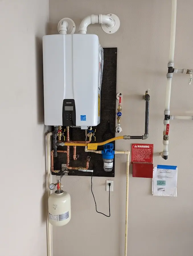 Professional plumber installing copper piping in a Parole home